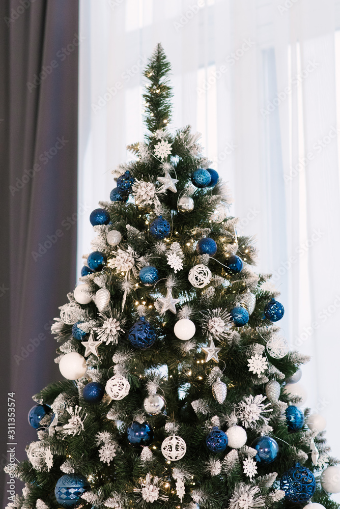 Christmas tree and other holiday decorations in white loft