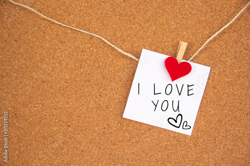 i love you red heart note on cork board