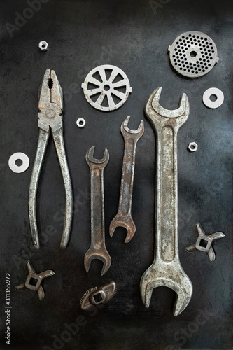 Repair tools are located in a creative composition for the interior. Steel tools decor. Working tools. Workshop.