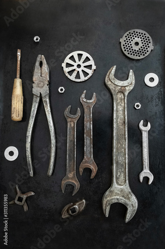 Repair tools are located in a creative composition for the interior. Steel tools decor. Working tools. Workshop.