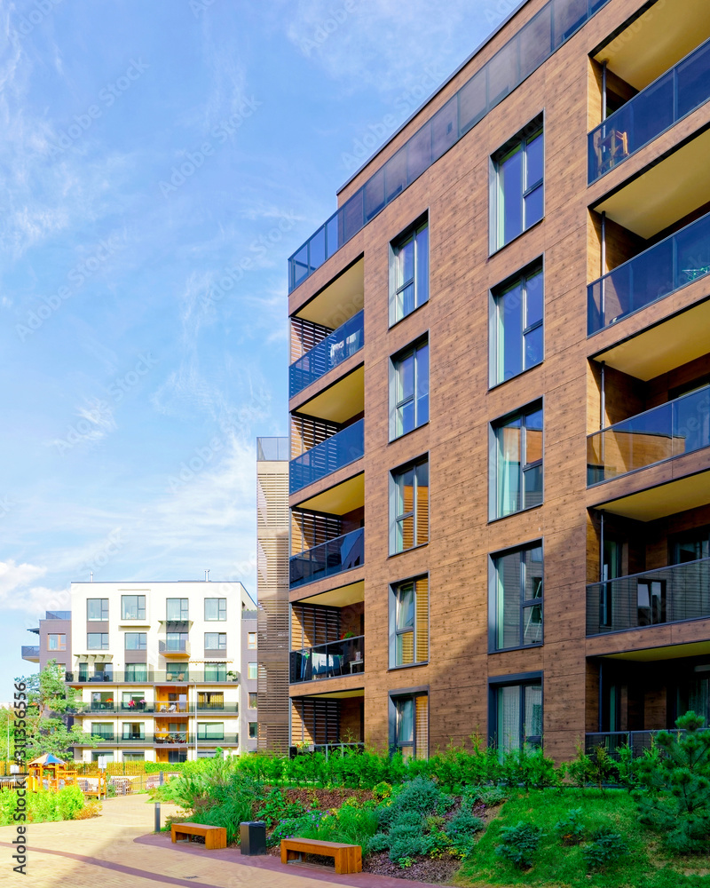 Benches at Modern architectural complex of apartment residential buildings reflex