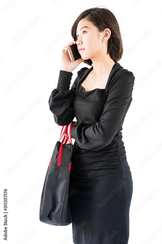 Woman carrying a black shopping bag using cellphone shopping online Woman carrying a black shopping bag using cellphone shopping online