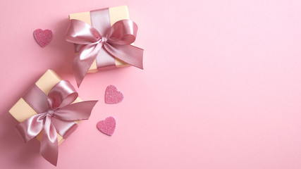 Happy Valentine's Day banner template with two gift boxes and Valentines hearts on pink background with copy space. Flat lay style, top view.