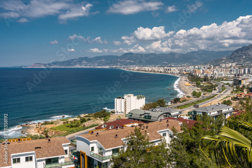 Fototapeta Naklejka Na Ścianę i Meble -  Mahmutlar city near Alanya. View from the mountain to the city, sea, beach and road