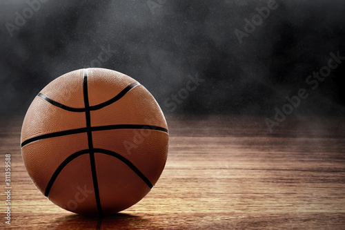Basketball ball on black background © fotokitas