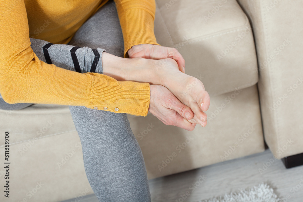 Middle-aged woman suffering from pain in leg at home, closeup. Physical injury concept. Middle-aged woman suffering from pain in leg at home, closeup. Physical injury concept.