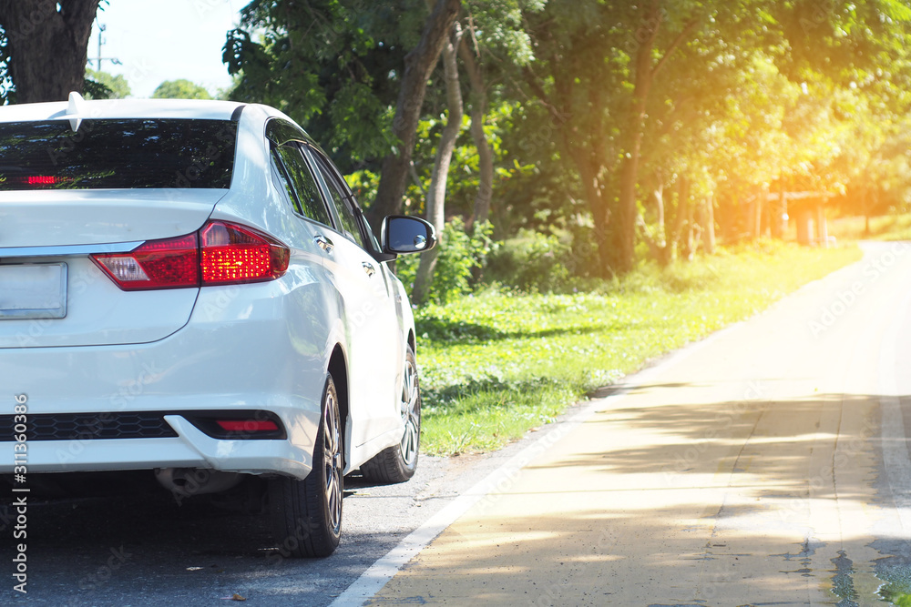 white car parking on road ,rear view of a car white car parking on road ,rear view of a car