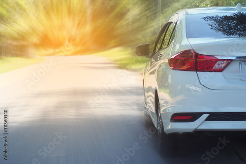 white car parking on road ,rear view of a car photo