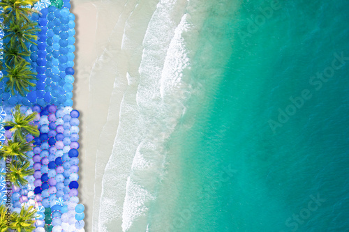 Aerial view tropical beach with colorful umbrellas with transparent blue water © Sunday Stock