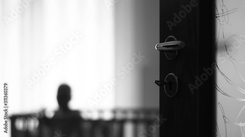 Little boy in a baby cot. Out of focus. Alone. Very lonely and sad.