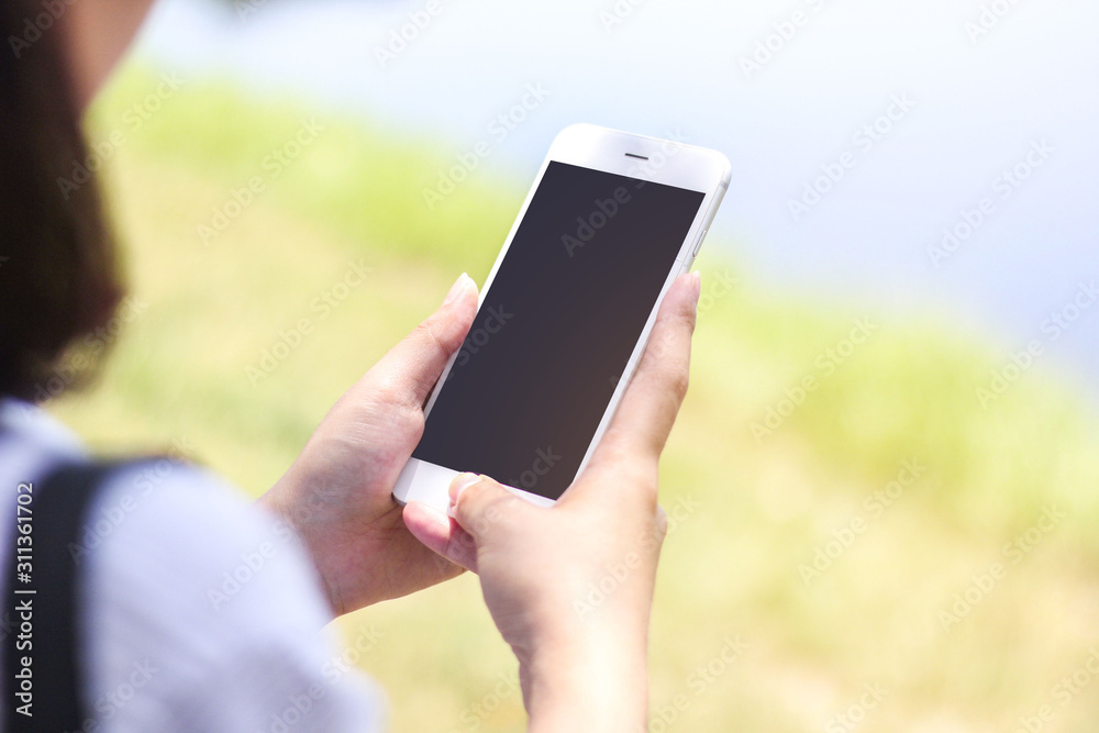 woman holding mobile phone with blank screen