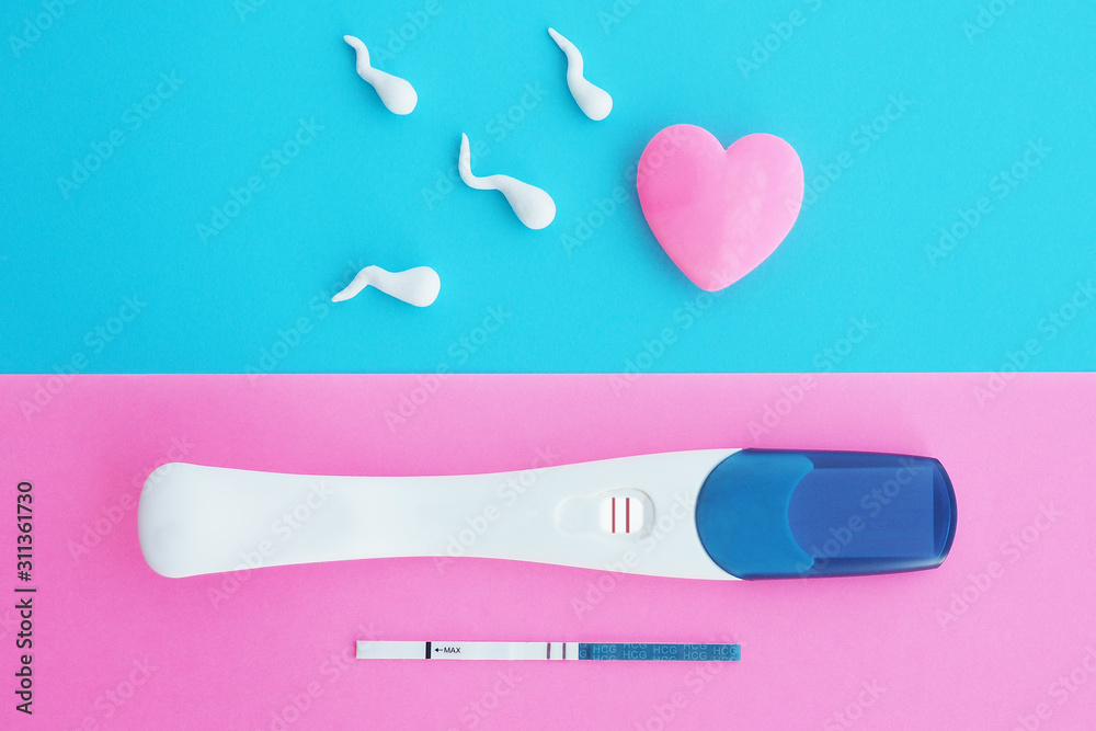 Two positive pregnancy tests with two stripes on a pink background and a pink heart with spermatozoa on a blue background. The concept of fertilization, pregnancy... Two positive pregnancy tests with two stripes on a pink background and a pink heart with spermatozoa on a blue background. The concept of fertilization, pregnancy...
