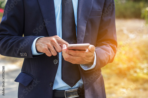 businessman holding a mobile phone