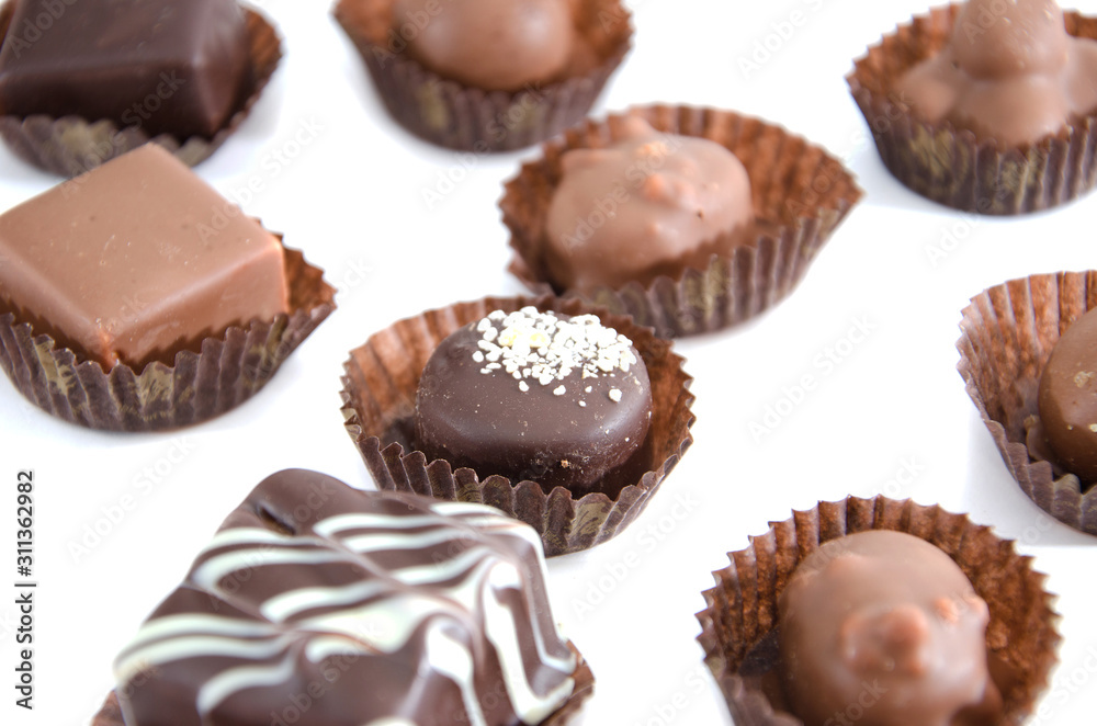 chocolate candies in a candy wrapper on a white background. A set of sweets with different tastes .. chocolate candies in a candy wrapper on a white background. A set of sweets with different tastes ..