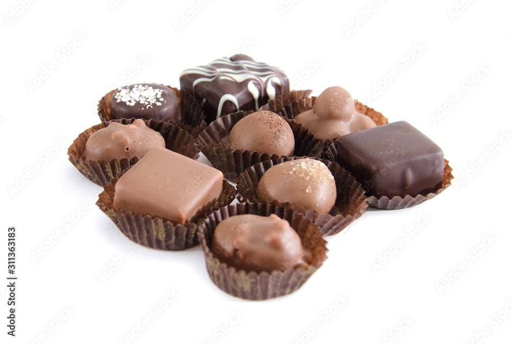 chocolate candies in a candy wrapper on a white background. A set of sweets with different tastes ..