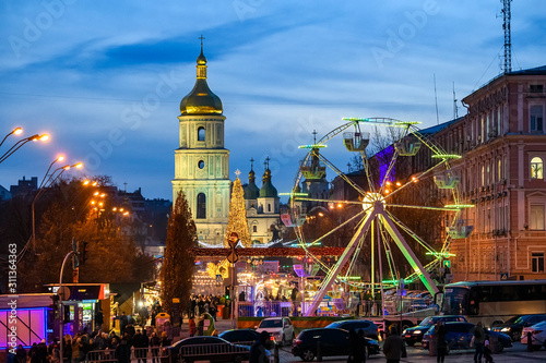 Street Decorated at bright festive illuminations and Christmas Tree on Sofia Square in Kyiv, Ukraine. December 2019