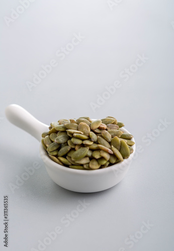 Dry pumpkin seeds in a small cup