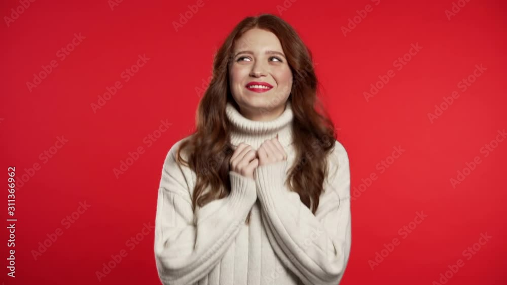Surprised excited happy woman. Portrait of beautiful young girl with ecstatic face expressions, she claps hands. Female shocked model on red background. Surprised excited happy woman. Portrait of beautiful young girl with ecstatic face expressions, she claps hands. Female shocked model on red background.