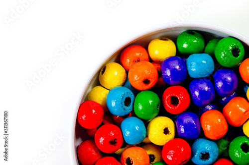 Wooden multi-colored beads for the manufacture of jewelry shot large on a white background