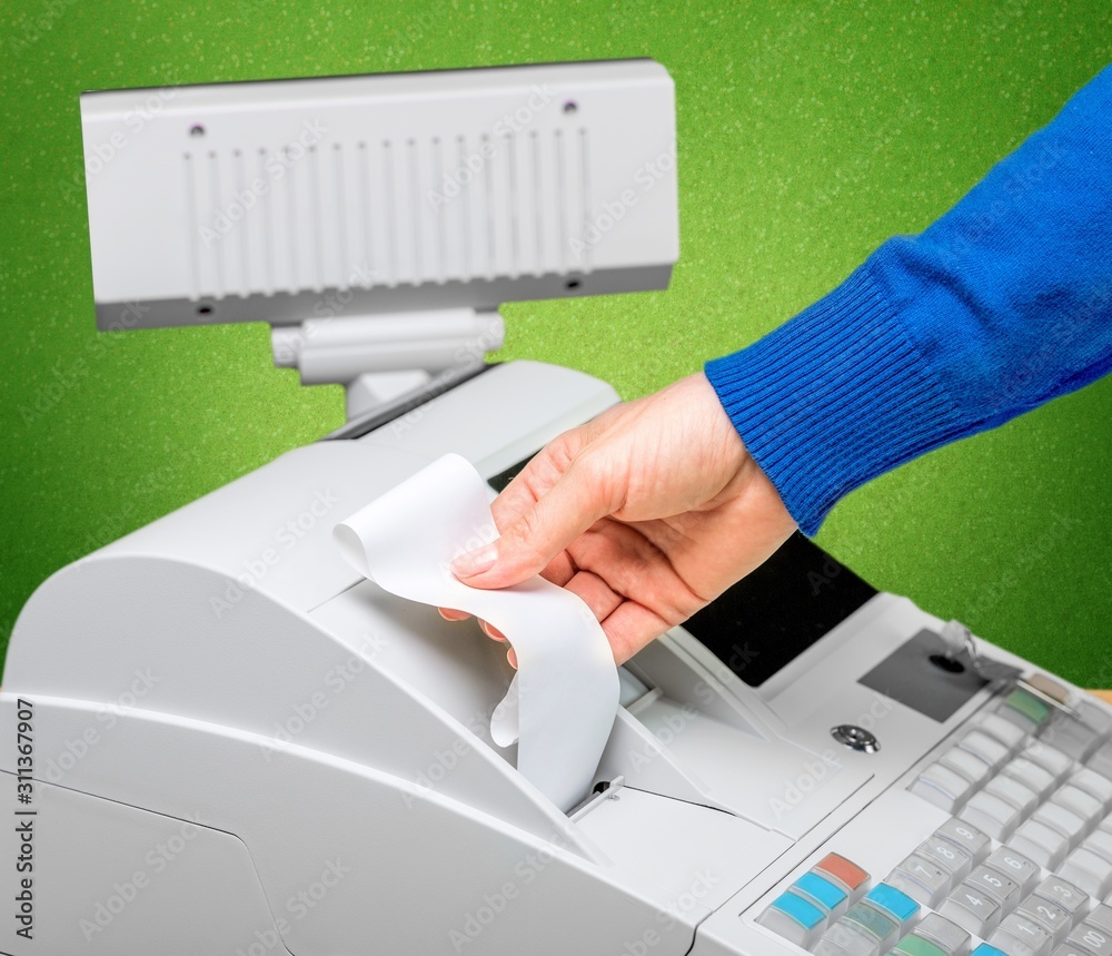 Cash register and worker's hand holding receipt paper Cash register and worker's hand holding receipt paper