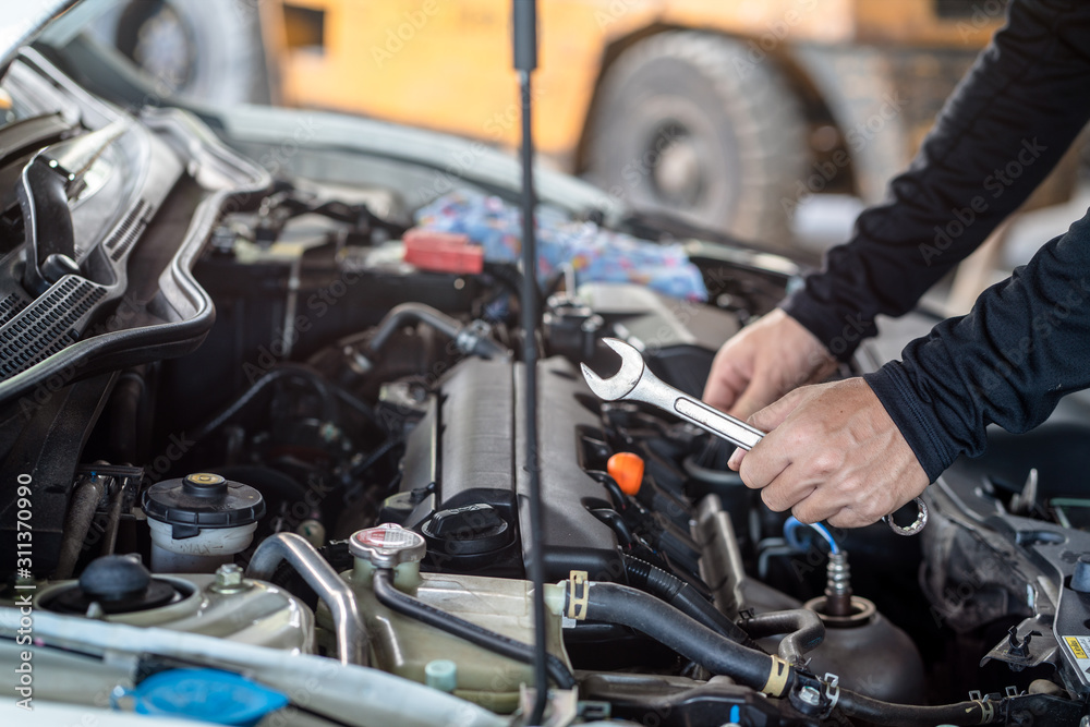 Hand of mechanic man hold spanner tool, inspection and maintenance car service Hand of mechanic man hold spanner tool, inspection and maintenance car service