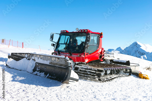 Snowplow car in a snow ski resort