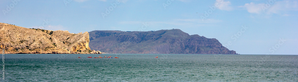 Beautiful summer sea landscape at the resort in the Crimea. Rocky coast of the black sea. Seascape. Panoramic banner.