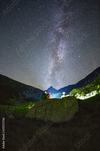 Couple under the milky way in Tatra Mountains photo