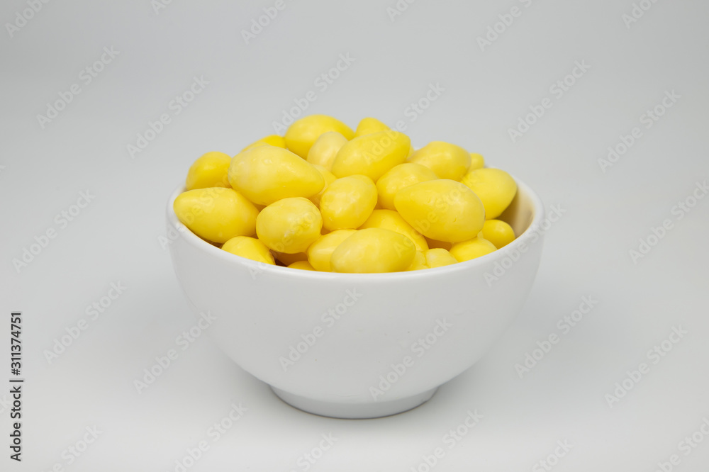 Ginkgo nuts in white bowl on white background