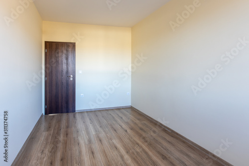 Empty bright room. New home interior. Wooden floor.