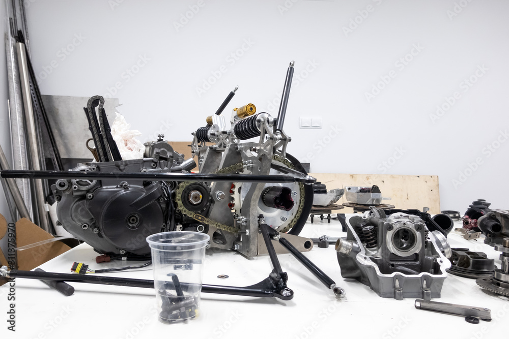 Sports car engine parts on the table. Assembling of vehicle engine. Car engine parts. Assembly of modern powerful car engine. Sports car engine parts on the table. Assembling of vehicle engine. Car engine parts. Assembly of modern powerful car engine.