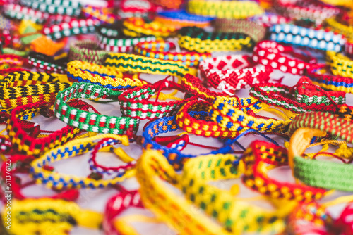 Colorful woven bracelets for sale at a Mexican market
