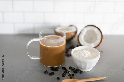 Cup of coffee with keto coconut creamer in white modern kitchen 