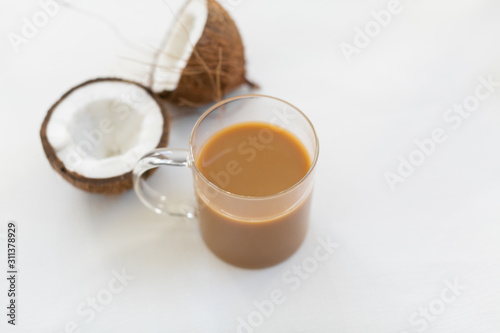 Coffee in clear glass mug with coconut creamer