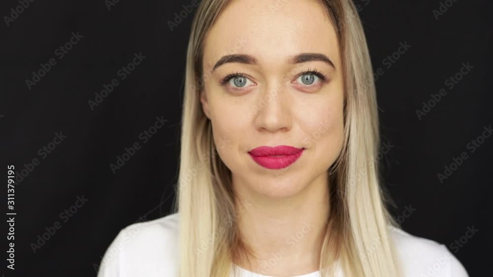 beautiful blonde woman with red lips and blue eyes. emotional long look. Video footage beautiful blonde woman with red lips and blue eyes. emotional long look. Video footage
