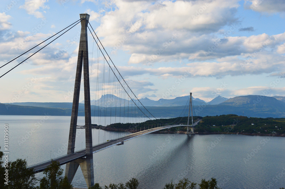 Suspension bridge connecting Islands with mountains in background in narvik, Norway
