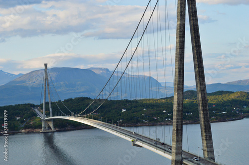 Suspension bridge connecting Islands with mountains in background in narvik, Norway