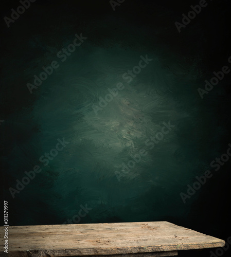 Wood table in front of rustic brick wall blur background with empty copy space on the table for product display mockup. Retro design montage presentation.