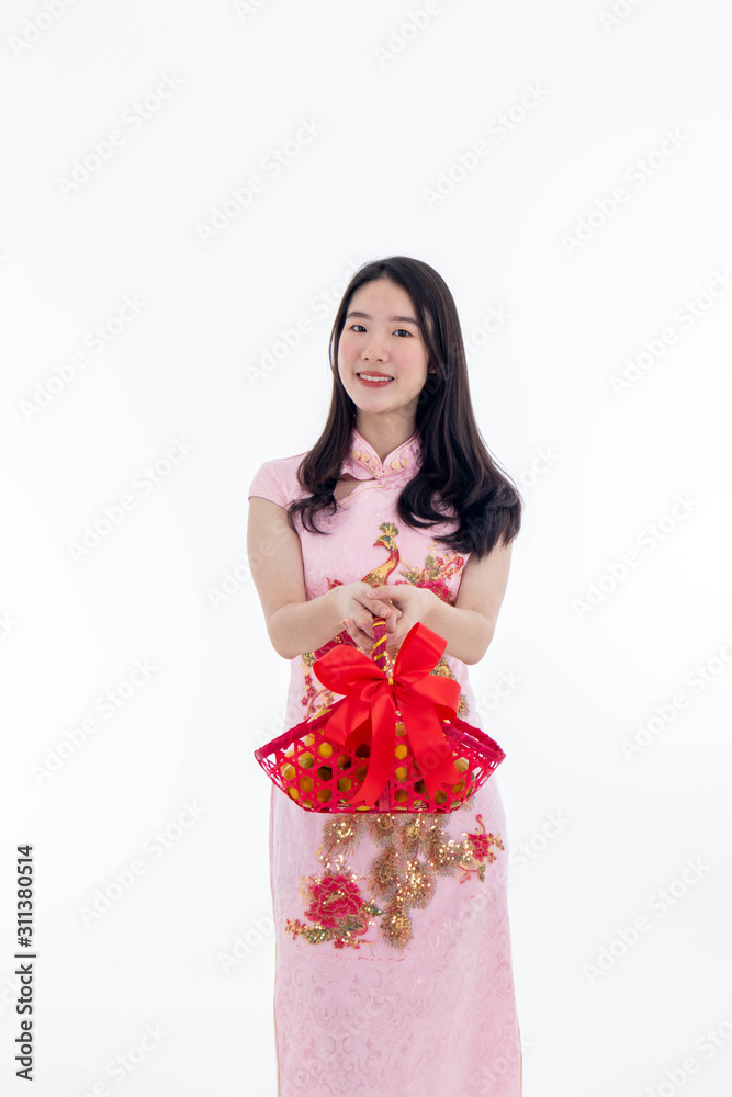 Chinese new year with Beauty smiling woman wears dresses traditional cheongsam and holds an orange basket, studio shot isolated on white background. Chinese new year with Beauty smiling woman wears dresses traditional cheongsam and holds an orange basket, studio shot isolated on white background.