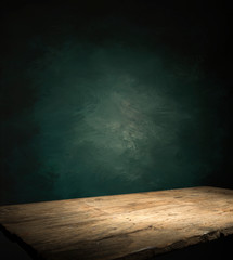Wood table in front of rustic brick wall blur background with empty copy space on the table for product display mockup. Retro design montage presentation.