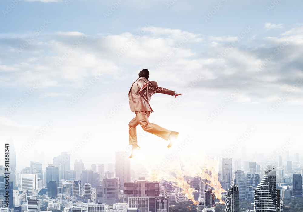 Businessman in suit and aviator hat flying in sky Businessman in suit and aviator hat flying in sky