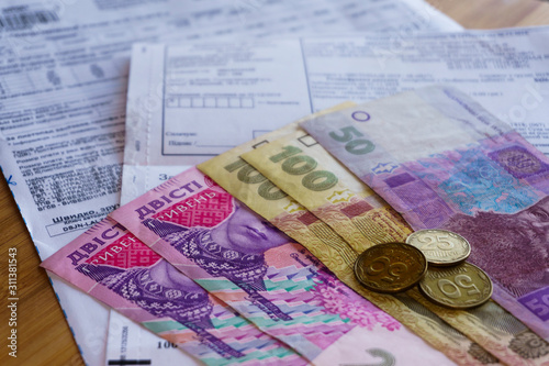Cuadro en lienzo Ukrainian money hryvnia and coins penny wooden background, utility bill