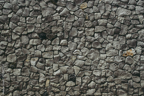 Wall of textured stones in dark colors
