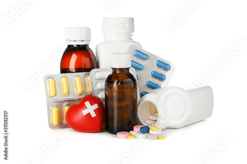 Medical bottles, heart and pills isolated on white background