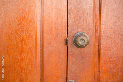 Closed up door knob on wood