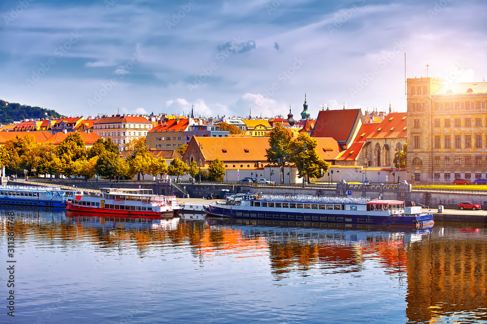 Scenic autumn sunset view of the Old Town pier architecture over Vltava river in Prague, Czech Republic