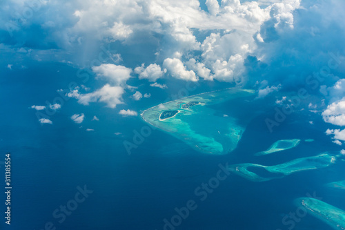 Aerial View of Maldives Island Beautiful blue sea with clouds and atolls famous tourist destination in the world