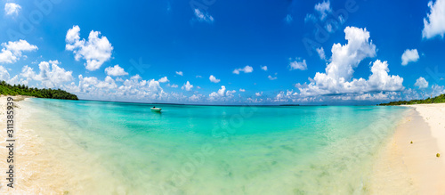 Panoramic View of Amazing Beach Funadhoo Island in Maldives turquoise color Sea with bright blue color sky and clouds Famous Place to travel in the world © sarath