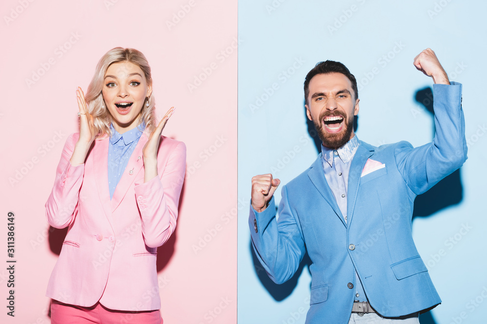 smiling woman and handsome man showing yes gesture on pink and blue background