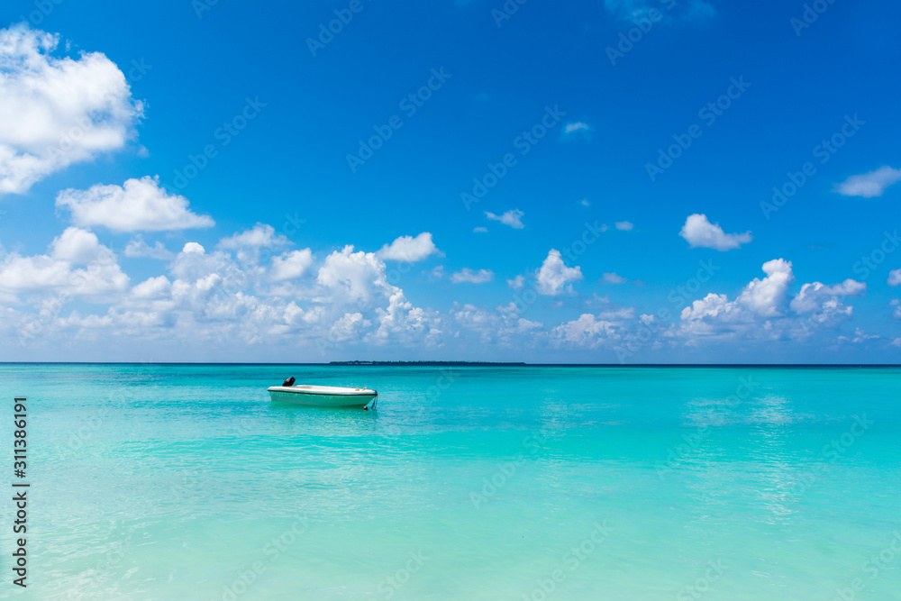 Beautiful Beach Nature Scenery of Maldive Funadhoo Island colorful sea and blue cloudy sky with alone boat Luxury travel summer holiday background concept